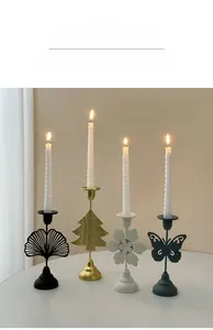 Detailed view of metal candle holders in leaf, tree, flower and butterfly shapes