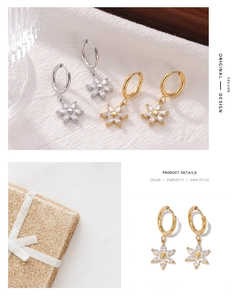 Detailed close-up of sunflower earrings with gold and silver finishes and zircon stones