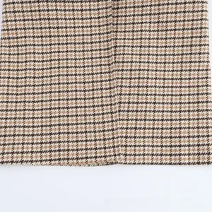 Detailed macro shot of the brown houndstooth woven fabric showing precise seam stitching