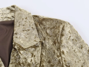 Detailed close-up of olive gold velvet blazer featuring silver sequin floral patterns