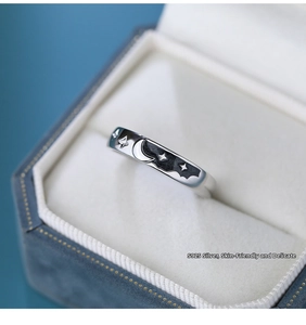 Macro shot of S925 silver ring featuring moon and stars in jewelry gift box