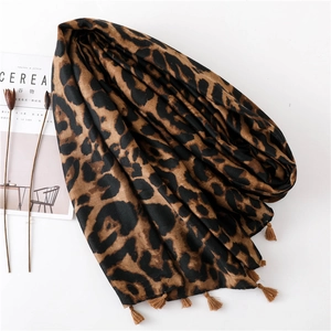 Leopard print pashmina shawl with fringe details shown from a 45-degree angle
