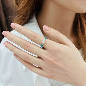 Detail of gold drip oil blue enamel ring with marquise white zircon inlay