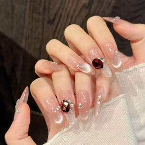 Luxury red gem almond press-on nails with cat eye finish and pearl rhinestones