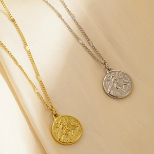 Minimalist stainless steel necklace featuring gold and silver bee coin pendants on a chain
