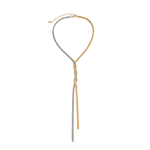 Detail of two-tone gold and silver snake bone chain with intertwined rhinestone tassel