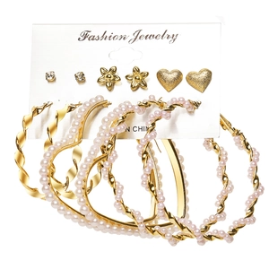 6-pair set of gold heart and pearl hoop earrings with rhinestone studs on display card