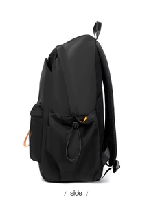 Side view of black waterproof backpack showing elastic side pocket and mesh back padding