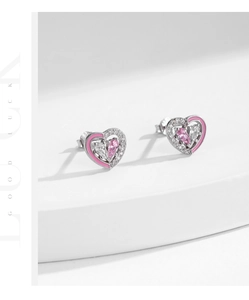 Close-up of heart stud earrings in pink enamel and sparkling cubic zirconia stones