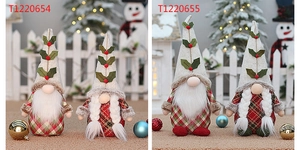Detail view of red and green plaid Christmas gnomes with white beards and holiday berries