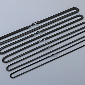 Detail view of five different widths of black stainless steel snake chain necklaces