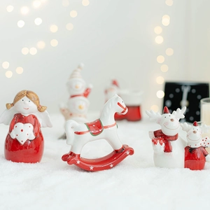 Ceramic Christmas ornaments featuring Santa and reindeer on a snowy festive background