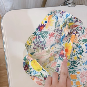 Detail view of cotton tote bag showing interior space and colorful floral pattern