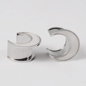 Polished moon-shaped ear stretchers in silver stainless steel with white shell inlays