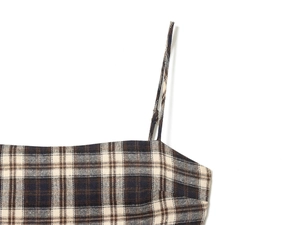 Detailed view of plaid camisole neckline and thin straps in dark blue and brown hues