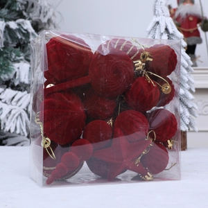Red flocked Christmas ornament set with velvet textures and gold hooks in a festive gift box