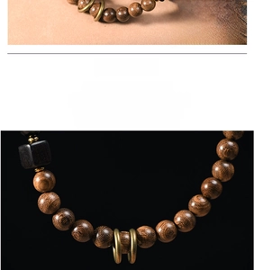 Macro shot of sandalwood beads showing wood grain and carved lion accessory
