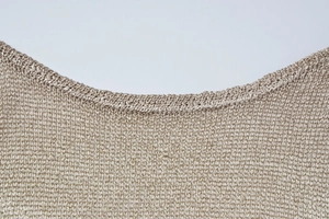 Close-up of the champagne mesh knit neckline showing the detailed stitching and texture