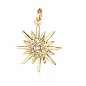Close-up of a golden sun pendant with a sparkling zircon center on a white background