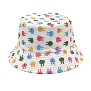 Detail of white cotton bucket hat featuring colorful cartoon rabbit prints and stitching