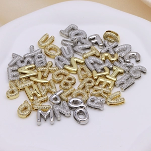 Close-up of sparkling gold and silver DIY alphabet charms with pavé cubic zirconia