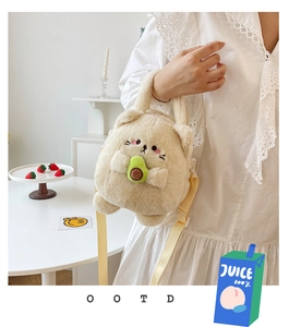 Detail of plush cat crossbody bag with cute avocado accessory and adjustable strap