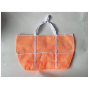 Close-up of orange mesh beach bag featuring durable white handles and nine storage pockets