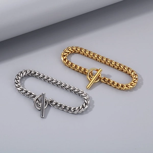 Detailed view of silver and gold Cuban link bracelets with modern OT toggle clasp