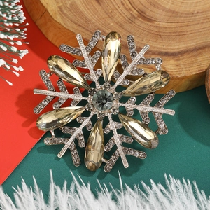 Detail shot of a silver snowflake brooch with champagne crystals and sparkling rhinestones