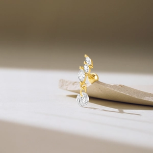 Detail of gold threaded cartilage stud with marquise and round cubic zirconia stones