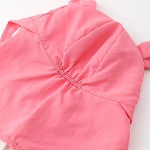 Close-up of pink sun hat featuring elastic pleated fabric and cute decorative ears