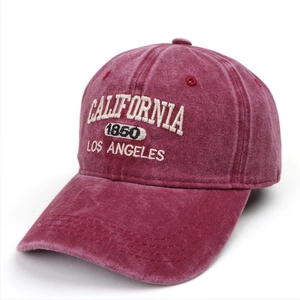 Macro detail of vintage washed burgundy baseball cap with white California embroidery