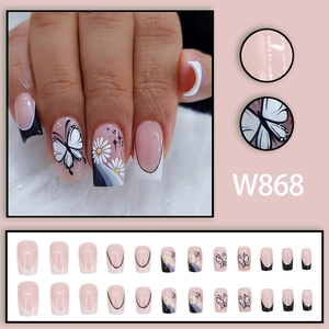 French press-on nails with black and white butterfly and daisy patterns on square tips