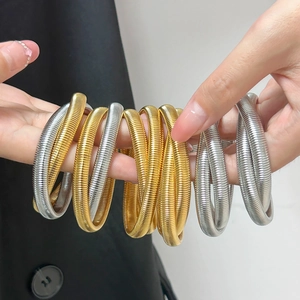 Chic multi-layer gold and silver spring bracelets set in a stylish stacked style