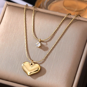 Vintage gold double-layer necklace with heart pendant and sparkling zircon stone