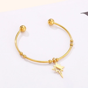 Detailed view of gold stainless steel open bangle with star pendant and bead accents