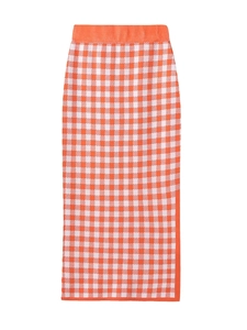 Detail of orange and white plaid knit midi skirt with fine texture and elastic waist
