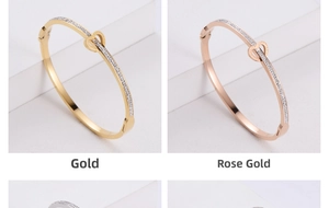 Detail of interlocking heart bracelets in gold and rose gold with pavé-set crystals