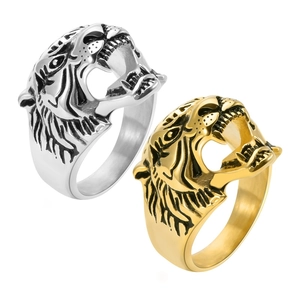 Close-up of vintage punk tiger head rings in silver and gold stainless steel finish