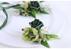 Detail of forest style PE rose boutonniere with green berries for outdoor weddings