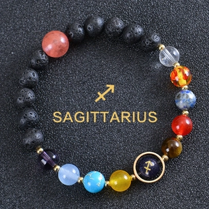 Macro shot of Sagittarius zodiac bracelet with black lava stone and colorful planet beads