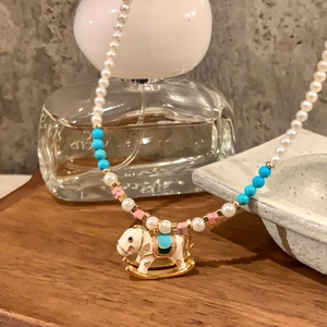 Elegant beaded pearl necklace with a colorful enamel rocking horse pendant for women
