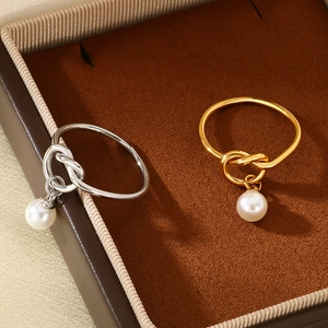Minimalist stainless steel knot rings with shell pearls in gold and silver finishes