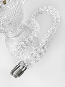 Close-up of clear acrylic link chain with silver metal buckle on vintage glass decor