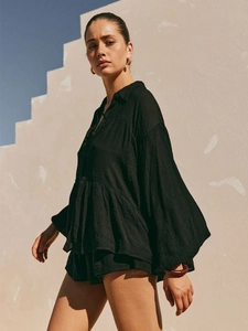 Detail of black two-piece lounge set with puff sleeves and elastic textured fabric