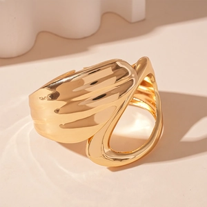 Detailed view of irregular geometric golden cuff bracelet with glossy mirror finish