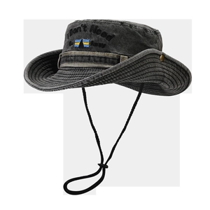 Detail of grey washed denim sun hat featuring embroidered text and adjustable wind cord