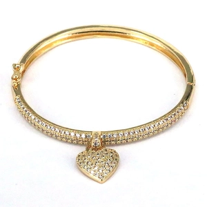 Close-up of golden adjustable heart bracelet with micro-paved sparkling crystals