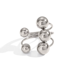 Close-up of a multi-layer silver ball ring with high-polished metallic spheres and open band