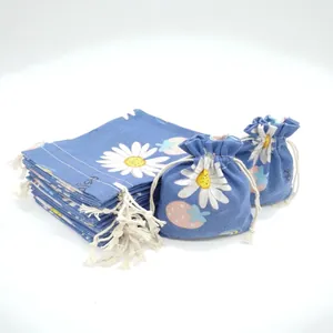 Floral cotton linen drawstring pouches with white daisy and strawberry patterns in blue